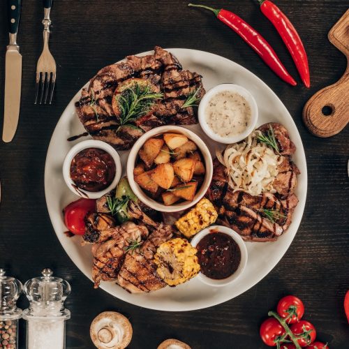 top-view-of-plate-with-beef-steaks-chicken-wings-and-wine-on-table-e1664110794933.jpg top-view-of-plate-with-beef-steaks-chicken-wings-and-wine-on-table-e1664110794933.jpg